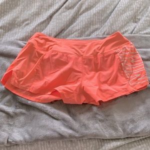 Coral Nike running shorts